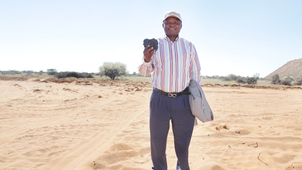 A flashback to 2003 when Ntsimbintle's Saki Macozoma, seen holding some of the hard grey manganese metal mined from the sands of Kalahari, turned the first sod at the Tshipi mine.